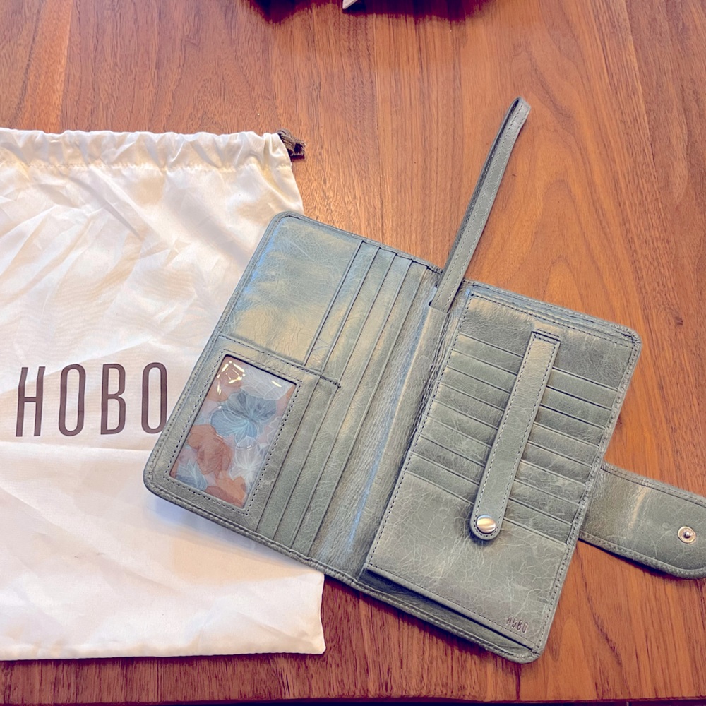 HOBO light green wristlet wallet. Wristlet strap slides back in as well.